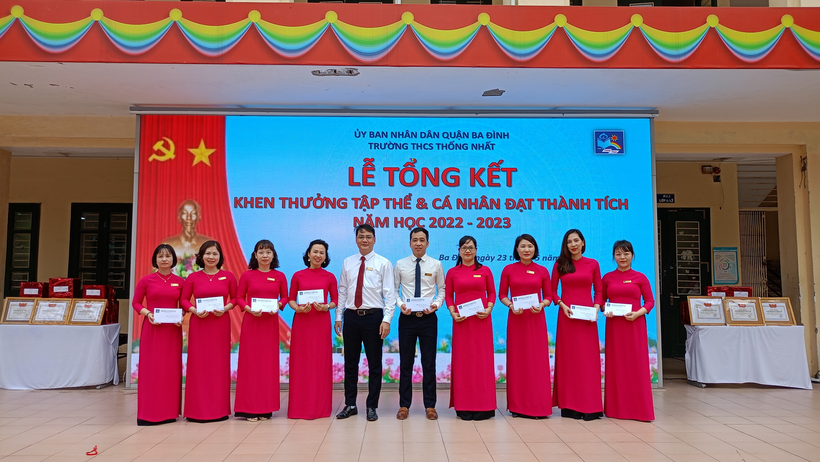 A group of people in red and white robes standing in front of a banner

Description automatically generated with low confidence